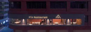 A well-lit restaurant dining area with tables and chairs, creating a cozy atmosphere for people to enjoy meals together