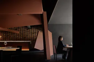 A casual restaurant with comfortable seating and a social atmosphere, featuring multiple chairs and a dining table