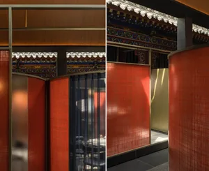 Dining area with tables and chairs in an Asian restaurant featuring red and gold walls, orange curtains, and decorative vases