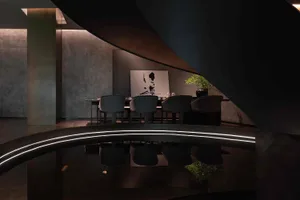 A modern living room with a dining table, chairs, potted plants, and a vase, set against a black and white background