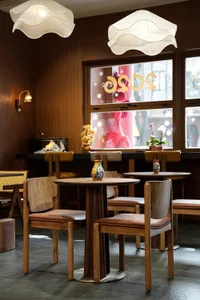 Warm and inviting restaurant interior with wooden floors and tables, multiple chairs, and ample seating options