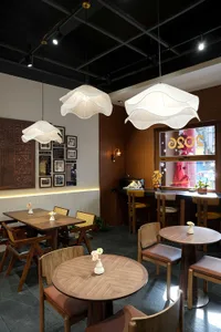 Warm and inviting restaurant interior with wooden tables and chairs, soft ambient lighting, and a cozy atmosphere