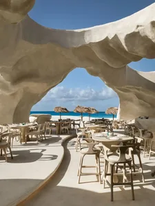 An outdoor restaurant with tables and chairs under umbrellas, providing a comfortable dining area