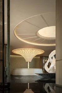 A modern room with a circular sculpture, white and beige walls, and a calm atmosphere, ideal for relaxation or social gatherings