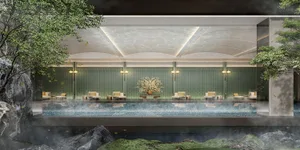 A large indoor pool surrounded by chairs and vases, creating a relaxing atmosphere for leisure activities