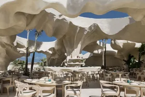 Cozy dining area with a large white rock formation, modern furniture, and warm lighting