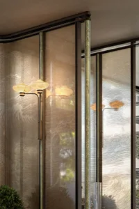 Dimly lit interior space with gold-accented glass doors, frosted glass panels, and a potted plant, featuring three table lamps and a cozy atmosphere