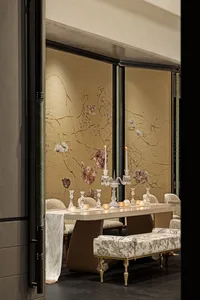 Dining area with a wooden table, candles, and wine glasses, creating a warm and inviting atmosphere