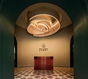 A modern hotel lobby with a red countertop, likely made of marble or granite, in an elegant and inviting atmosphere