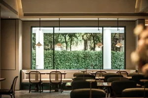 Dining area with multiple tables and chairs, well-lit for a comfortable atmosphere