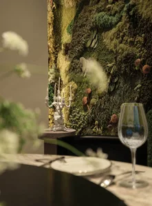 Dining area with a wooden table, two chairs, and a wine glass, creating an elegant and inviting atmosphere