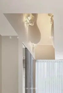 A modern hallway with a lighted wall, curtains, and a well-lit atmosphere
