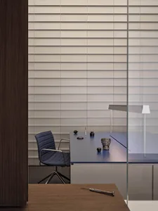 A professional office space with a desk, chair, cups, and a vase, set in a well-organized atmosphere