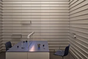 A professional office space with a wooden desk, chair, and various office items, set against a neutral background