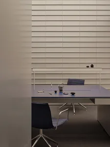 A professional office space with a desk and two chairs, featuring cups and a bowl, in a well-organized atmosphere