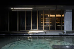 Indoor pool with a circular design, surrounded by chairs and a luxurious atmosphere