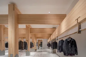 A spacious office building with wooden walls, marble floors, and a warm atmosphere