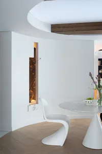 Elegant dining space with a glass table surrounded by modern chairs, perfect for hosting gatherings or enjoying meals together
