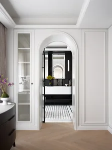 Sophisticated bathroom with a large mirror above a sink, vases, and a potted plant adding a touch of greenery