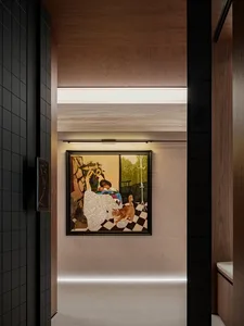 A painting of a well-lit living room with a dog on a chair in front of a window, surrounded by a black frame