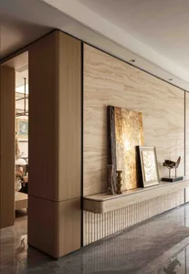 A modern living area with glass doors leading to a patio, featuring two couches, a chair, and a dining table with chairs, creating a comfortable and inviting atmosphere