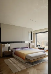 A large bedroom with a king size bed, two chairs, and a couch, featuring a window for natural light and a clean, organized appearance