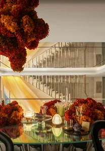 A staircase with wooden steps and two chandeliers, set against a sophisticated backdrop
