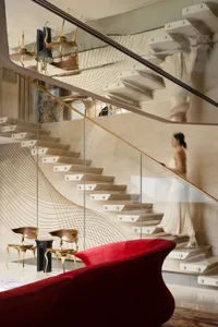 A modern staircase with marble steps, clean lines, and minimalistic design elements, set in a well-lit space with a sophisticated atmosphere