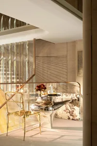 Dining room with a wooden table and chairs, a vase, and a couch, creating a comfortable and inviting atmosphere