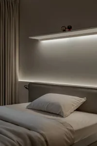 Cozy bedroom with a large white bed, wooden headboard, and two small figurines on the bed