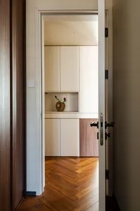 Clean and organized kitchen with cabinets, countertop, and a decorative vase on the countertop