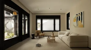 Open living space with a white couch, two chairs, and white walls, creating a bright and airy atmosphere