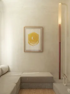 Empty living room with a white couch against a concrete wall, two lamps, and a calm atmosphere