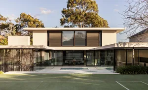 A modern house with glass walls, a pool, and outdoor furniture, surrounded by a relaxing atmosphere of luxury and comfort