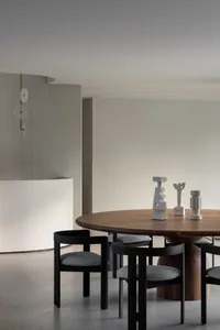 A calm and inviting dining area with a wooden table and chairs, ready for guests to gather