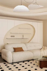 Cozy modern living space with a fabric sofa, bookshelf, and minimalistic decoration