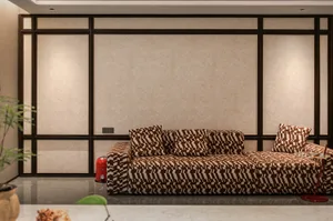 Cozy living room with a brown couch, zebra print pillows, and a potted plant on a hardwood floor, with a fire hydrant in the corner