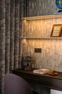 Cozy study with a desk, two chairs, and a warm atmosphere, featuring a unique patterned wall design