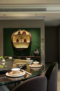 A dining area with a wooden table and chairs, surrounded by wine bottles on a shelf, in a restaurant with an elegant and sophisticated ambiance