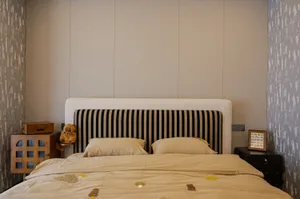 Cozy bedroom with a striped bed, two teddy bears, and a warm atmosphere
