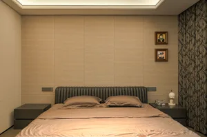 Cozy bedroom with a large wooden bed, brown sheets, and two framed pictures on the wall