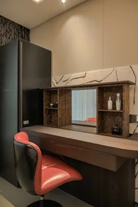 Elegant bathroom with a wooden vanity, sink, and mirror, accompanied by two chairs and bathroom essentials