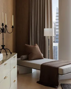 Cozy bedroom with a large bed, wooden furniture, and natural light from a window
