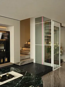 Open modern living space with a glass door, marble stairs, a bookshelf, and a cozy atmosphere