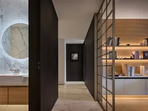 A hallway with wooden floors and walls, featuring two doors and a well-organized layout