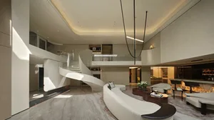 A modern living area with a white couch, two chairs, a clock, and a potted plant, creating a spacious and inviting atmosphere