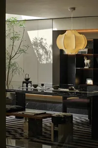 Sophisticated dining space with a black marble table, two chairs, and decorative vases
