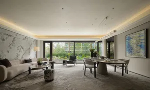 Open living space with a white table, chairs, couches, and a vase, giving a clean and contemporary feel