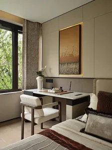 A cozy living space with a large window, two chairs, a dining table, a couch, and a vase, flooded with natural light