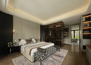 Spacious bedroom with a brown and white comforter, two couches, chairs, a dresser, and a dining table, creating a cozy and inviting atmosphere with neutral tones and earthy hues